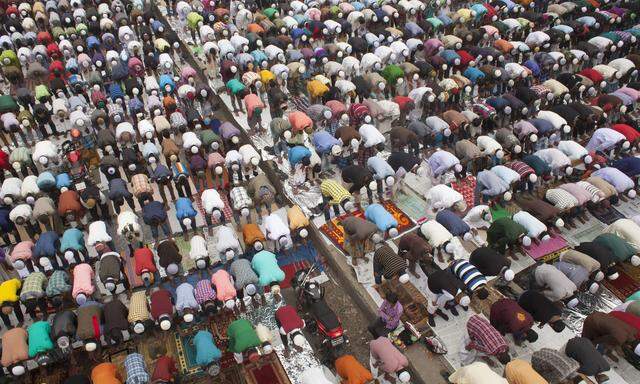 Thousands of Muslims attend the Friday prayer in the streets close to the congregration ground durin