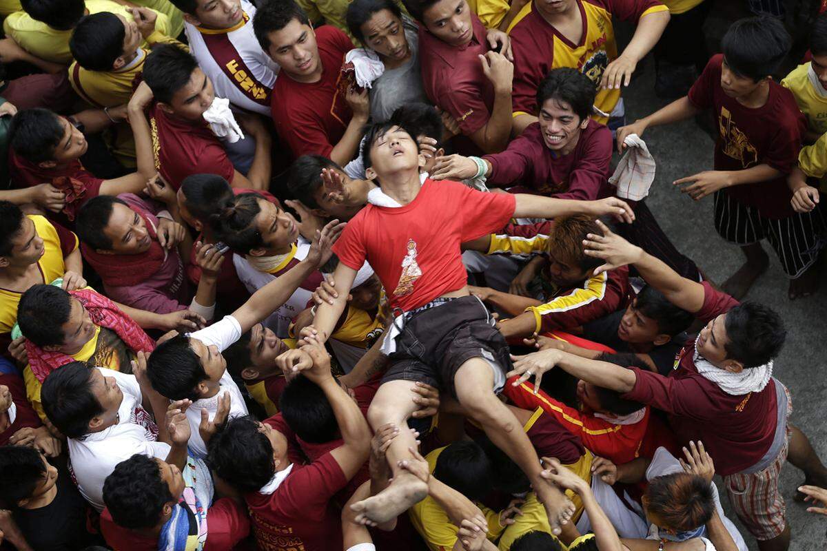 Nach Angaben der Behörden von Manila wurden im Gedränge mindestens 120 Menschen verletzt. Im Bild: Ein ohnmächtiger junger Mann wird über den Köpfen der Masse in Richtung Erstversorgung getragen.