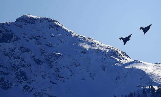Two Eurofighter Typhoon aircrafts fly over the Streif course during an aerial exhibition before the start of the men's Alpine Skiing World Cup Super G race in Kitzbuehel