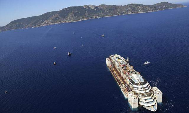 Handout aerial photo of the Costa Concordia cruise liner leaving Giglio island after the refloat operation