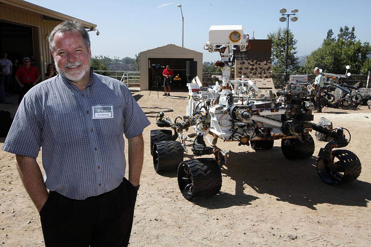 "Das wird keine gemütliche Luftkissen-Landung. Auf dem Mars aufzusetzen, ist immer sehr riskant", sagte Nasa-Manager Doug McCuistion. Und die Ingenieure können eigentlich nur zuschauen. Der Landevorgang selbst wird vollautomatisch ablaufen.Im Bild: Rob Manning, Nasa-Chefingenieur, mit einem Curiosity-Prototypen.