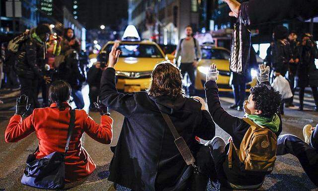 Demonstrators block a street in Lower Manhattan while they protest a grand jury decision not to charge a New York policeman in the choking death of Eric Garner, in New York