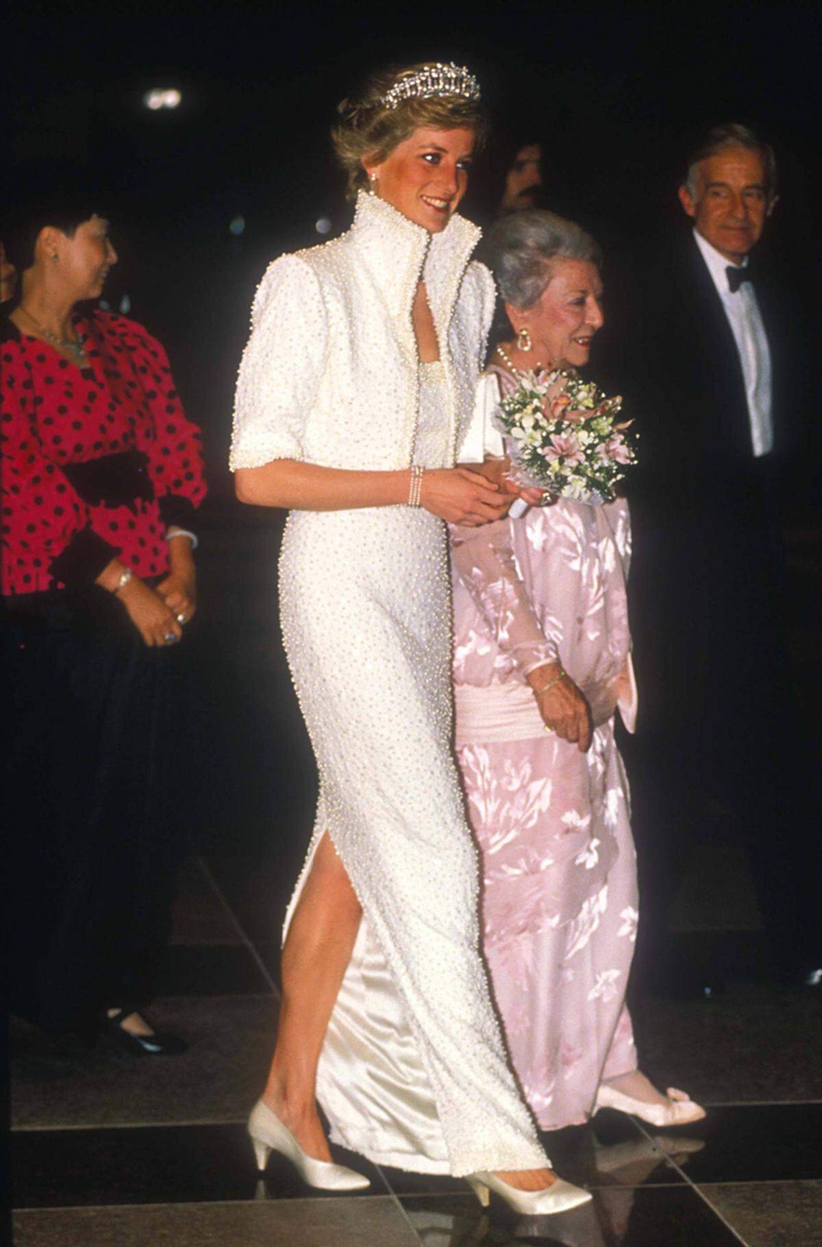 1989 legte sie in diesem weißen Perlenkleid von Catherine Walker in Hongkong einen spektakulären Auftritt hin. Den Tribut an Hongkong, die "Perle des Orients", nannte sie selbst ihr "Elvis-Kleid".    