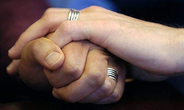 ***File*** Stuart Gaffney, left, and John Lewis, right, partners for 19 years, embrace hands with the