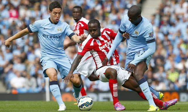 Manchester City's Toure and Nasri challenge Stoke City's Moses during their English Premier League soccer match at the Etihad stadium in Manchester