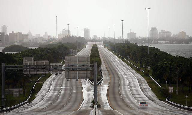A car drives along an empty highway in Miami before the arrival of Hurricane Irma to south Florida