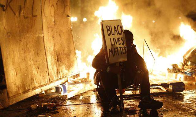 during a demonstration in Oakland, California following the grand jury decision in the shooting of Michael Brown in Ferguson, Missouri