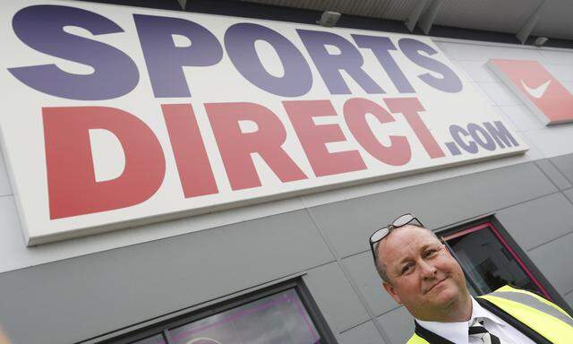 Mike Ashley, founder and majority shareholder of sportwear retailer Sports Direct, leads journalists on a factory tour after the company´s AGM, at the company´s headquarters in Shirebrook