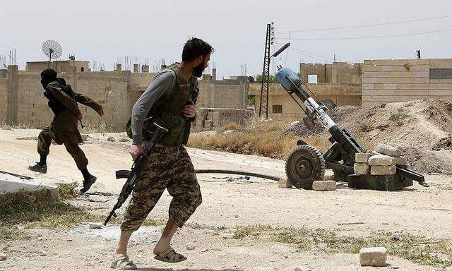  Free Syrian Army fighters run before firing a locally made launcher in Mork town