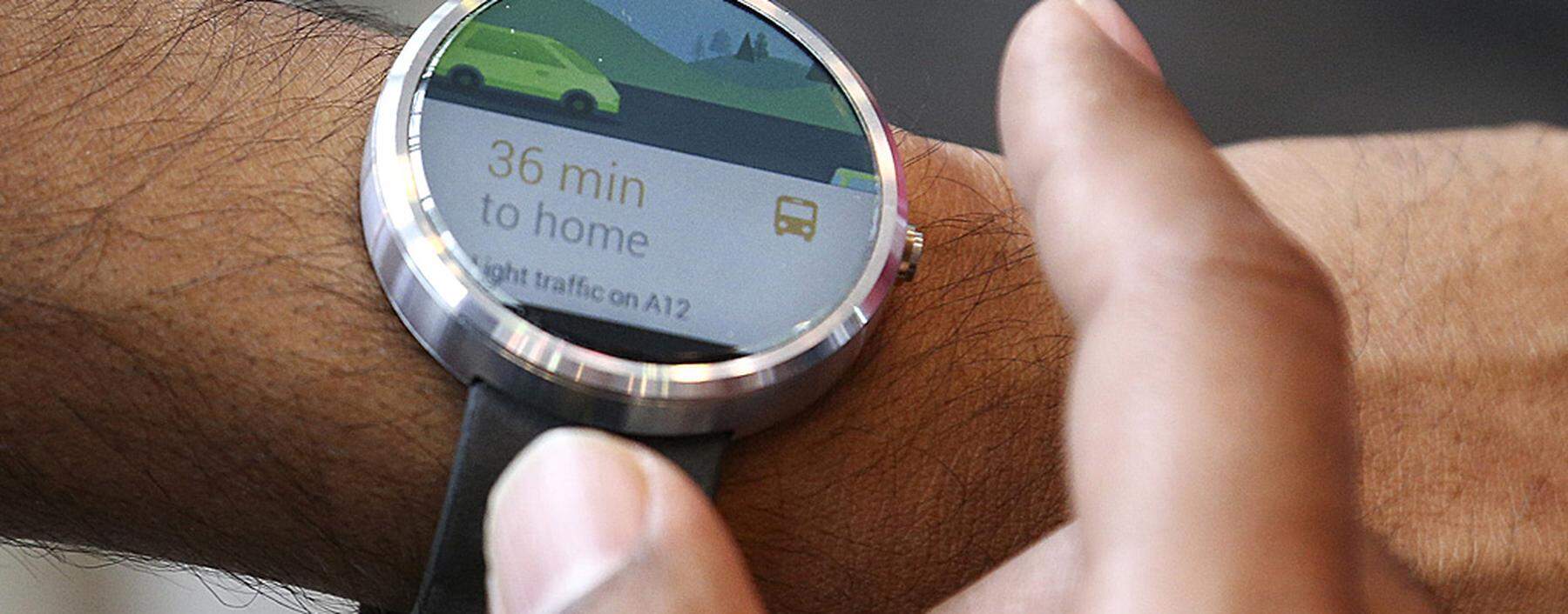 A Google employee demonstrates the features of the Moto smartwatch at the Google I/O developers conference in San Francisco