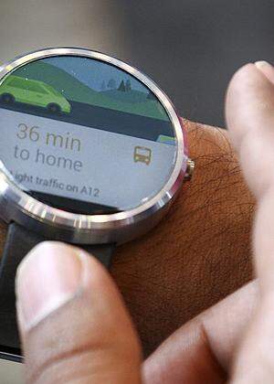 A Google employee demonstrates the features of the Moto smartwatch at the Google I/O developers conference in San Francisco