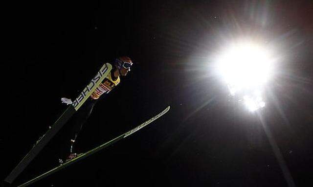 Kofler from Austria soars through the air during the qualification for the 60th four hill ski jumping