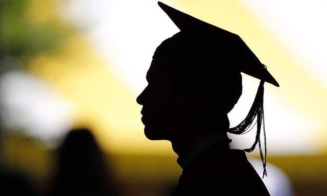 File of students taking their seats for the diploma ceremony at Harvard University in Cambridge