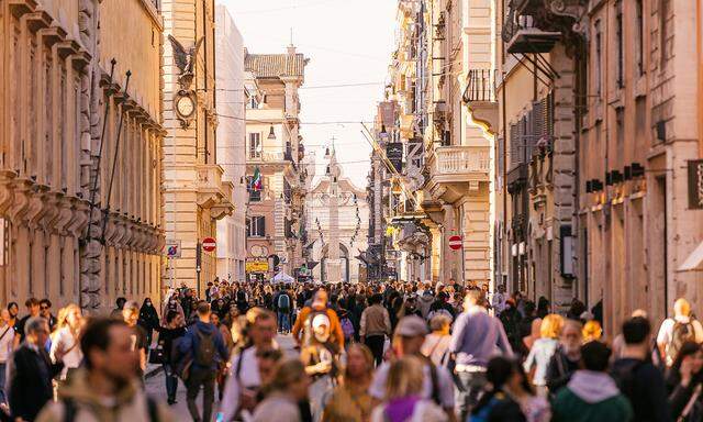 Crowds of people on Via Del Corso shopping street in Rome, Italy