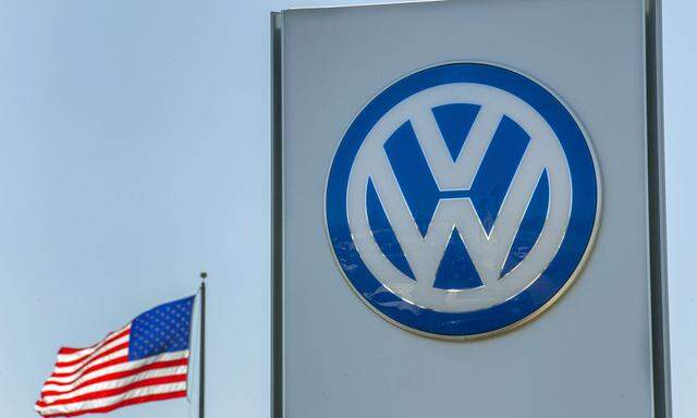 FILE PHOTO - An American flag flies next to a Volkswagen car dealership in San Diego
