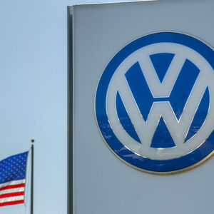 FILE PHOTO - An American flag flies next to a Volkswagen car dealership in San Diego
