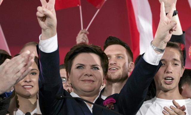 Szydlo, Poland´s main opposition party Law and Justice candidate for prime minister in the upcoming parliamentary election flashes a victory sign during the party convention in Warsaw