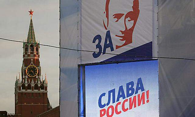 The portrait of Vladimir Putin and a slogan reading Glory to Russia are seen as stage decoration as