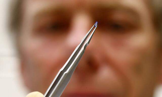 Physicist Duerig uses tweezers to hold a silicon tip at a laboratory in Rueschlikon