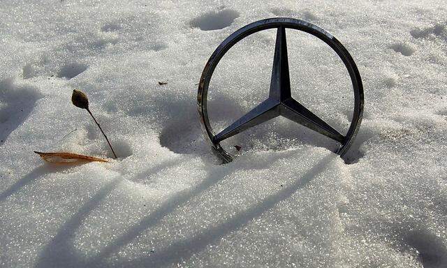 German car manufacturer Daimler's characteristic Mercedes-Benz star is seen on a snow covered vehicle in Bucharest