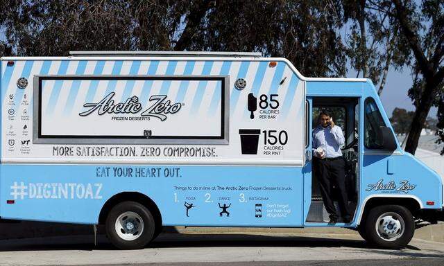 Arctic Zero Chief Executive Amit Pandhi talks on the phone at the entrance of his healthy frozen dessert ice cream truck in San Diego