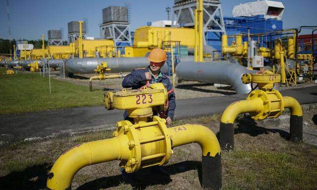 A worker turns a valve at an underground gas storage facility near Striy