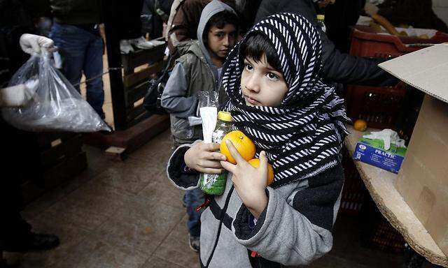 A child makes his way after receiving food from the Orthodox Church of Greece in Athens