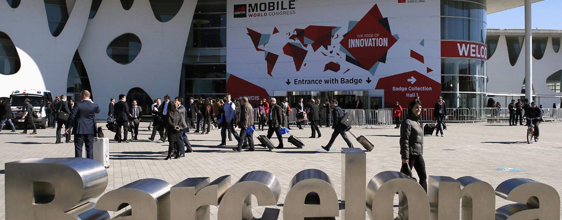 People walk next to the Mobile World Congress banner in Barcelona