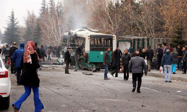 People react after a bus was hit by an explosion in Kayseri