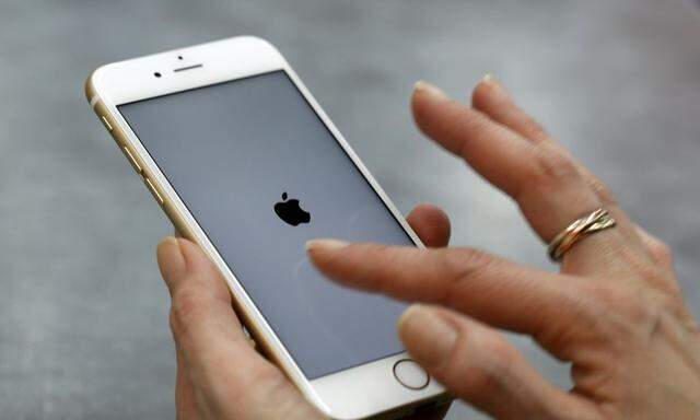 File photograph of a woman using her mobile phone in Munich