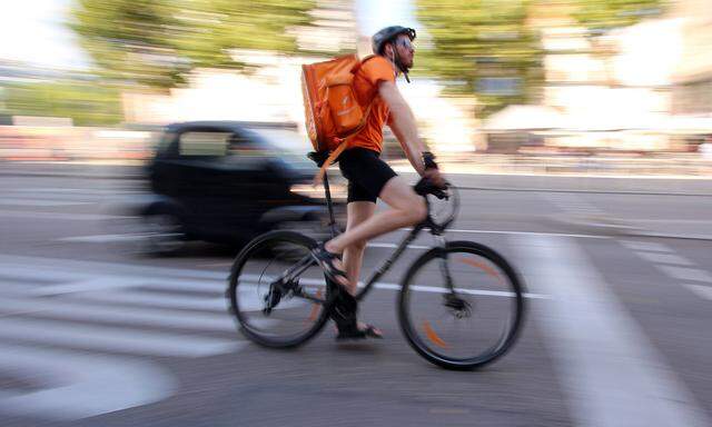 Fahrradkurier vom Internet Portal Lieferando liefert warme Speisen in der Innenstadt Stuttgart aus