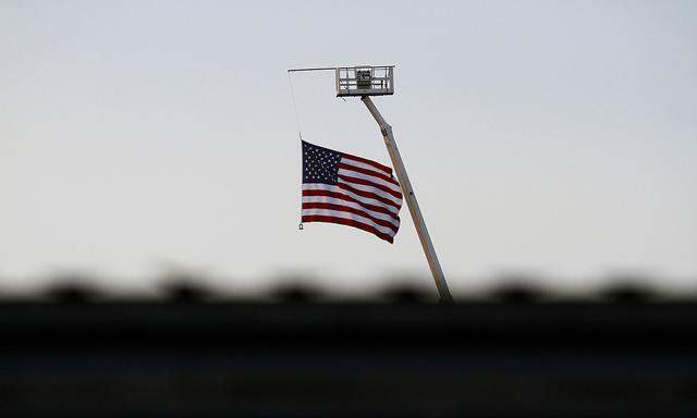 The U.S. flag flies behind the current border fence in this picture taken from the Mexican side of the border in Tijuana