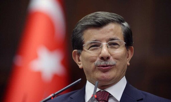 TurkeyÂ´s PM Davutoglu addresses members of the parliament from his ruling AK Party (AKP) during a meeting at the Turkish parliament in Ankara