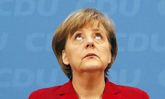 German Chancellor and leader of CDUMerkel looks up during news conference after party meeting in Berl