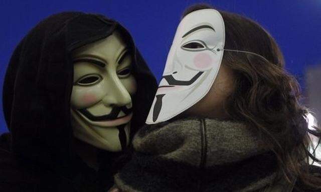 WikiLeaks supporters wear masks during a demonstration in Malaga