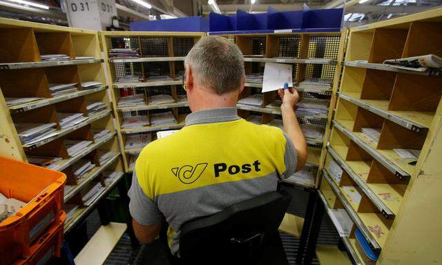 A worker sorts mail at Austrian Post logistics centre in Vienna