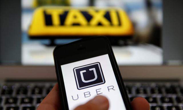 An illustration picture shows the logo of car-sharing service app Uber on a smartphone next to the picture of an official German taxi sign