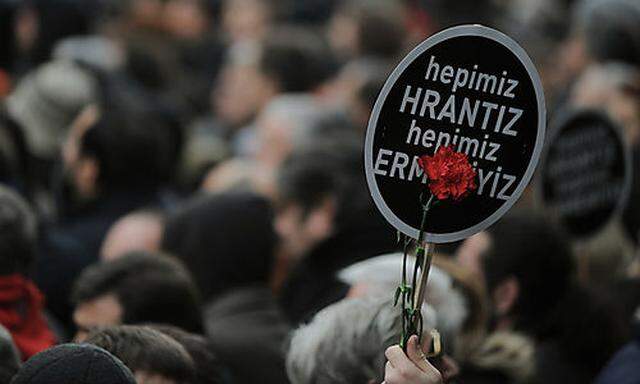 A person holds a banner that reads We are all Hrant, we are all Armenian as some tens of thousands 
