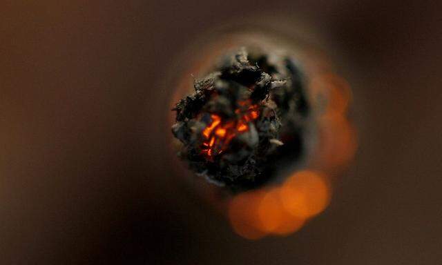 A woman smokes a cigarette in a bar in downtown Zurich