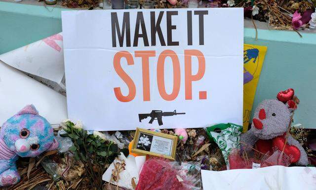 A sign stands in the Marjory Stoneman Douglas High School memorial during a rally for solidarity in