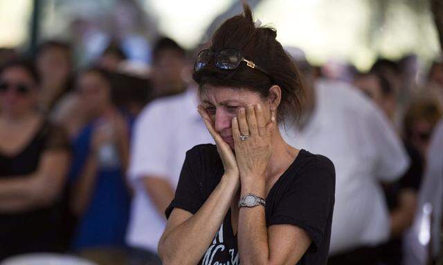 A woman reacts at the funeral of Israeli soldier Daniel Kedmi in Tel Aviv