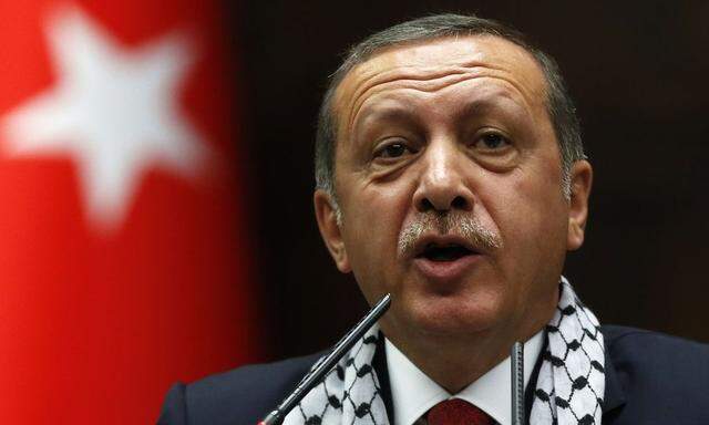 Turkey's PM Erdogan addresses members of parliament from his ruling AK Party during meeting at Turkish parliament in Ankara