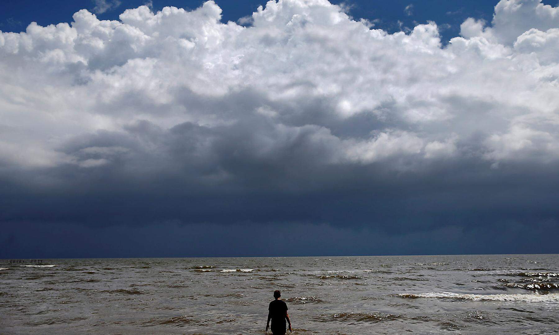 15-year-old Jordan Carambat wades in the ocean as Tropical Storm Gordon approaches Waveland