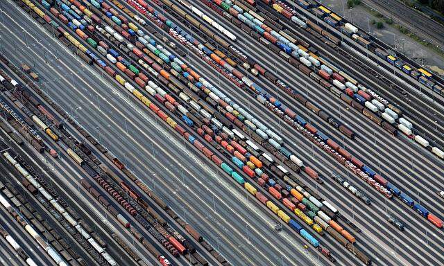 FILE PHOTO: Containers and cars are loaded on freight trains at the railroad shunting yard in Maschen near Hamburg