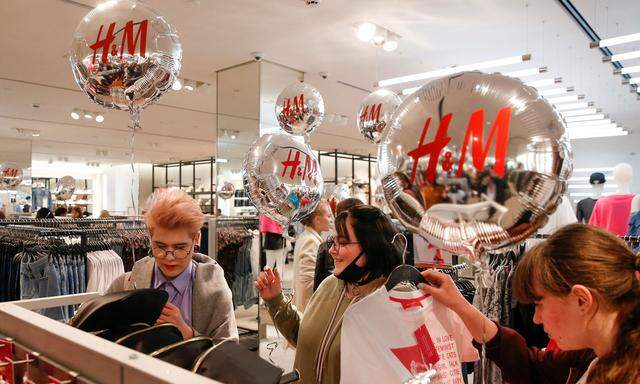 FILE PHOTO:People shop at the Swedish fashion retailer H&M store on its opening day in central Moscow