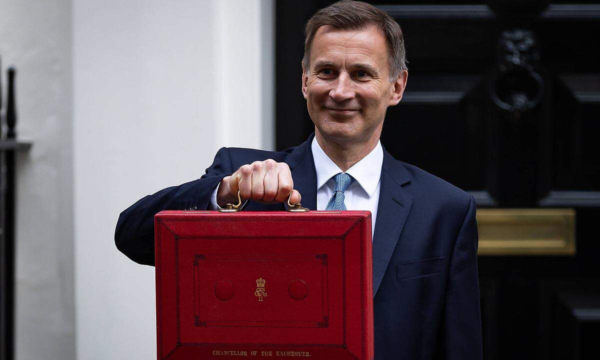 March 15, 2023, London, United Kingdom: Chancellor of the Exchequer, Jeremy Hunt displays the red budget briefcase to th