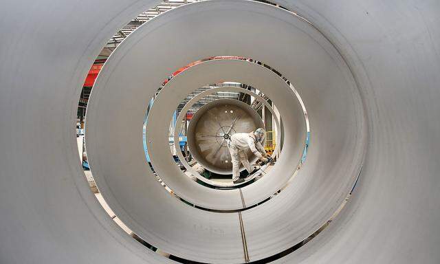 Employee works on the production line of tanks for liquefied natural gas (LNG) at an energy equipment company in Nantong