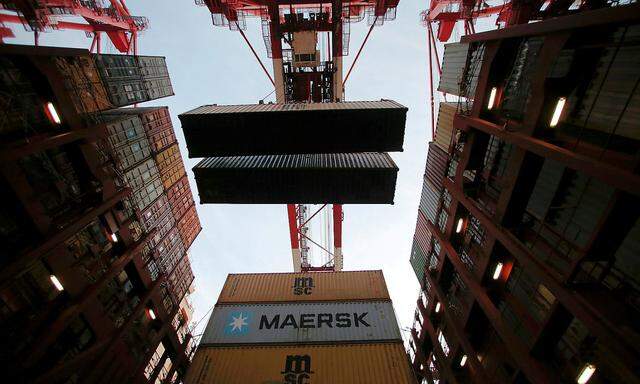 Containers are seen unloaded from the Maersk's Triple-E giant container ship Maersk Majestic, one of the world's largest container ships, at the Yangshan Deep Water Port, part of the  Shanghai Free Trade Zone, in Shanghai