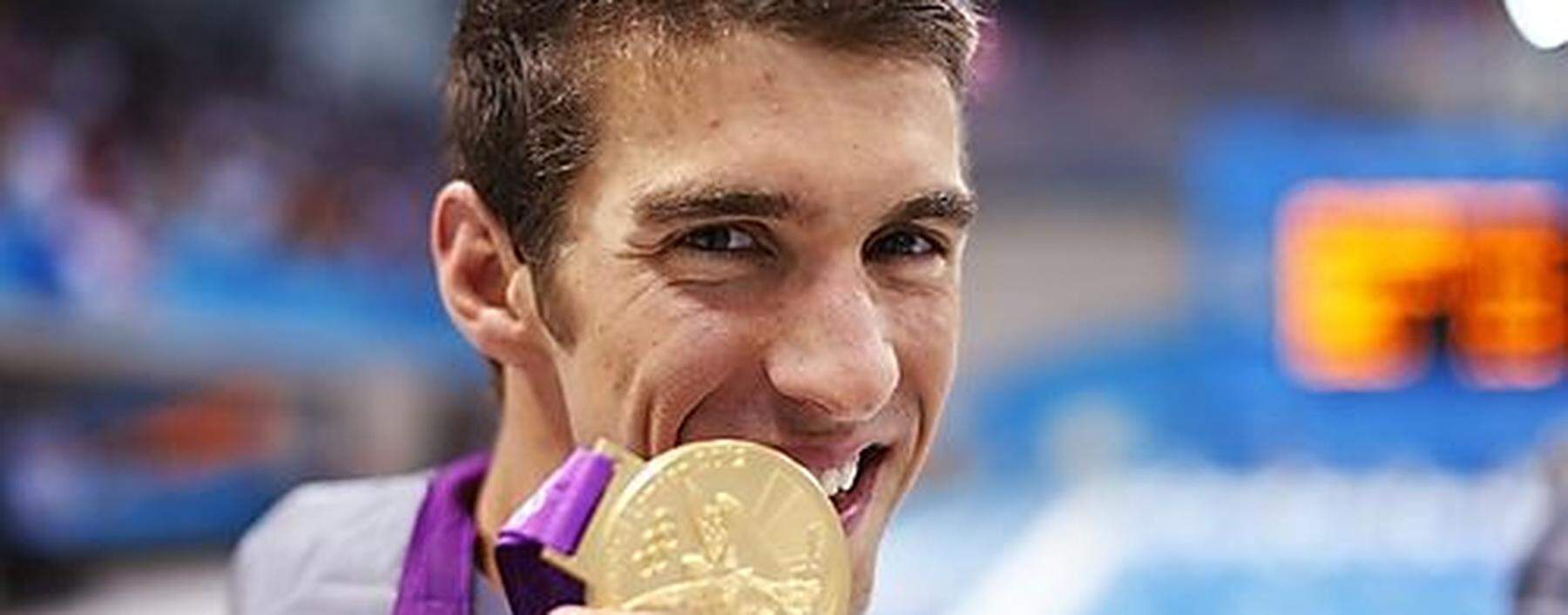 Michael Phelps of the U.S. poses with his gold medal after winning the men's 4x100m medley relay final during the London 2012 Olympic Games at the Aquatics Centre