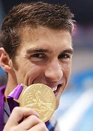 Michael Phelps of the U.S. poses with his gold medal after winning the men's 4x100m medley relay final during the London 2012 Olympic Games at the Aquatics Centre